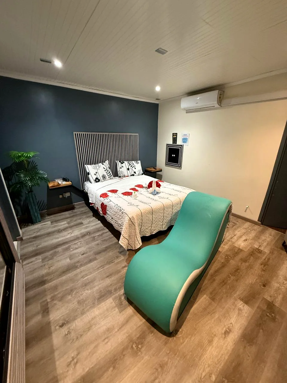 Habitación con cama y sillón en tonos verdes